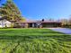 Brick ranch home with an attached two car garage and large front yard under a clear blue sky at 935 Fry Rd, Greenwood, IN 46142