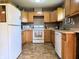 Functional kitchen featuring light wood cabinets, laminate countertops, and white appliances at 935 Fry Rd, Greenwood, IN 46142