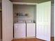 Laundry closet with white washer and dryer units, and ample shelving for storage at 935 Fry Rd, Greenwood, IN 46142