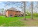 Lush green backyard, mature trees and a cozy deck area offer a serene outdoor space at 945 Baywood Ct, Columbus, IN 47201