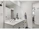 Bathroom with double sinks, an extra-long mirror, and access to another room at 945 Baywood Ct, Columbus, IN 47201