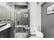 Modern bathroom with glass shower, decorative tile, dark vanity and sleek fixtures at 945 Baywood Ct, Columbus, IN 47201