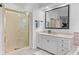 Bright bathroom featuring a glass shower, vanity with plenty of storage, and a large mirror at 945 Baywood Ct, Columbus, IN 47201