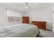 Comfortable bedroom features a ceiling fan, closet, dresser, and a window letting in lots of natural light at 945 Baywood Ct, Columbus, IN 47201