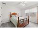 Bright bedroom with neutral walls, plush carpeting, wooden bed frame, and natural light from the window at 945 Baywood Ct, Columbus, IN 47201