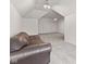 Bright bonus room features neutral walls, plush carpet and a comfortable brown couch at 945 Baywood Ct, Columbus, IN 47201