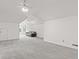 Open bonus room with neutral walls, plush carpet, ceiling fans and comfortable brown couch at 945 Baywood Ct, Columbus, IN 47201