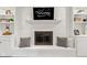 Living room fireplace featuring white brick with built-in shelves and a TV at 945 Baywood Ct, Columbus, IN 47201