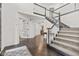 Spacious foyer with hardwood floors, grand staircase, and multiple entryways at 945 Baywood Ct, Columbus, IN 47201