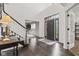 Bright foyer with hardwood floors, staircase, and an open view to other living spaces at 945 Baywood Ct, Columbus, IN 47201