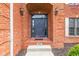 Close-up of the front door with brick surround and address plate at 945 Baywood Ct, Columbus, IN 47201