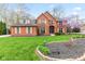 Charming brick home with a manicured lawn, blossoming tree, and welcoming curb appeal at 945 Baywood Ct, Columbus, IN 47201