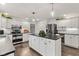 Well-equipped kitchen with stainless steel appliances, white cabinetry, and a spacious island at 945 Baywood Ct, Columbus, IN 47201