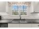 Kitchen with a view, showcasing a double sink with a window overlooking the greenery at 945 Baywood Ct, Columbus, IN 47201