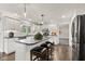 Modern kitchen featuring white cabinets, a large island, and sleek black countertops at 945 Baywood Ct, Columbus, IN 47201