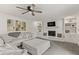 Bright living room featuring a painted fireplace, built-in shelves, ceiling fan and comfortable seating at 945 Baywood Ct, Columbus, IN 47201