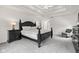 Inviting main bedroom with dark wood accents, trey ceiling, carpet, and gray chair at 945 Baywood Ct, Columbus, IN 47201