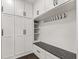 Organized mudroom featuring ample storage cabinets, a bench, and convenient hooks for coats and bags at 945 Baywood Ct, Columbus, IN 47201