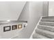 Carpeted staircase featuring a gray color scheme and artwork on the wall at 945 Baywood Ct, Columbus, IN 47201