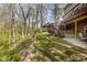 Charming backyard featuring a deck with stairs, lush greenery, and a peaceful wooded area at 9838 Gulfstream Ct, Fishers, IN 46037