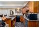 Finished basement bar with wood cabinets, bar seating and dark countertops at 9838 Gulfstream Ct, Fishers, IN 46037