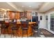 Finished basement bar area features stylish seating, wood cabinetry, and dark countertops at 9838 Gulfstream Ct, Fishers, IN 46037