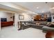 Spacious basement featuring a large sectional sofa and wet bar, perfect for entertaining guests at 9838 Gulfstream Ct, Fishers, IN 46037