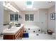 Bright bathroom featuring double sinks, a skylight, and a soaking tub at 9838 Gulfstream Ct, Fishers, IN 46037