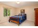Cozy bedroom featuring a natural view from the window and a wooden bed with blue bedding at 9838 Gulfstream Ct, Fishers, IN 46037