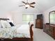 Well-lit bedroom with vaulted ceilings, light carpet, and a classic wood dresser and mirror set at 9838 Gulfstream Ct, Fishers, IN 46037