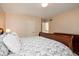 Cozy bedroom featuring floral bedding, a wooden dresser, and a glimpse into an adjoining room at 9838 Gulfstream Ct, Fishers, IN 46037