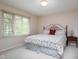 Comfortable bedroom with a large window providing natural light and a decorative metal headboard at 9838 Gulfstream Ct, Fishers, IN 46037