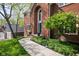 View of home from walkway showing mature landscaping, the brick facade, and teal front door at 9838 Gulfstream Ct, Fishers, IN 46037