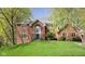 Charming brick home featuring a well-manicured lawn and lush trees, enhancing its curb appeal at 9838 Gulfstream Ct, Fishers, IN 46037