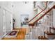 Elegant foyer with hardwood floors, a grand staircase, and a view into the living room at 9838 Gulfstream Ct, Fishers, IN 46037