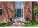 Inviting front entrance with a teal door, sconces, potted plants, and brick steps at 9838 Gulfstream Ct, Fishers, IN 46037
