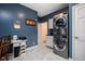 The laundry room features a stacked washer and dryer, with nearby desk and storage space at 9838 Gulfstream Ct, Fishers, IN 46037