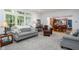 Cozy living room with gray sofa, a leather chair and open to the dining area at 9838 Gulfstream Ct, Fishers, IN 46037
