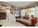 Leather sofa with decorative pillows sits in comfortable room featuring adjacent doorways and eclectic art at 9838 Gulfstream Ct, Fishers, IN 46037