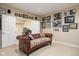 Comfortable room featuring a leather sofa with unique pillows and adjacent doorway at 9838 Gulfstream Ct, Fishers, IN 46037
