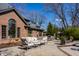 Elegant brick home featuring a charming stone patio with comfortable seating and a serene backyard setting at 10605 Winterwood, Carmel, IN 46032