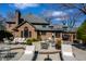 Well-appointed backyard patio with stone flooring, outdoor seating, and a barbecue area, ideal for gatherings at 10605 Winterwood, Carmel, IN 46032