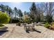 Stone patio with multiple seating areas and a landscaped yard provides space to enjoy the outdoors at 10605 Winterwood, Carmel, IN 46032