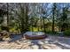 Above ground brick enclosed spa sits on a stone patio surrounded by mature trees at 10605 Winterwood, Carmel, IN 46032