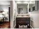 Bathroom vanity with dark wood cabinets, woven storage baskets, and neutral countertop offers ample storage at 10605 Winterwood, Carmel, IN 46032