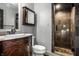 Cozy bathroom features a dark wood vanity with a marble countertop and a glass-enclosed shower at 10605 Winterwood, Carmel, IN 46032