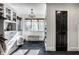 Spacious walk-in closet with custom shelving, chandelier lighting, and a comfortable seating area at 10605 Winterwood, Carmel, IN 46032