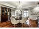 Elegant dining room featuring hardwood floors, a chandelier, and custom wallpaper at 10605 Winterwood, Carmel, IN 46032