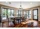 Dining room featuring a table with seating, chandelier, and large picture windows at 10605 Winterwood, Carmel, IN 46032