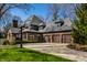 Stunning brick home with a three-car garage, basketball hoop, and lush green lawn in a desirable neighborhood at 10605 Winterwood, Carmel, IN 46032